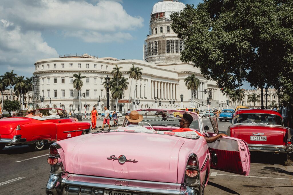 Kuba Rundreise – roter Oldtimer in Havanna vor kolonialer Architektur